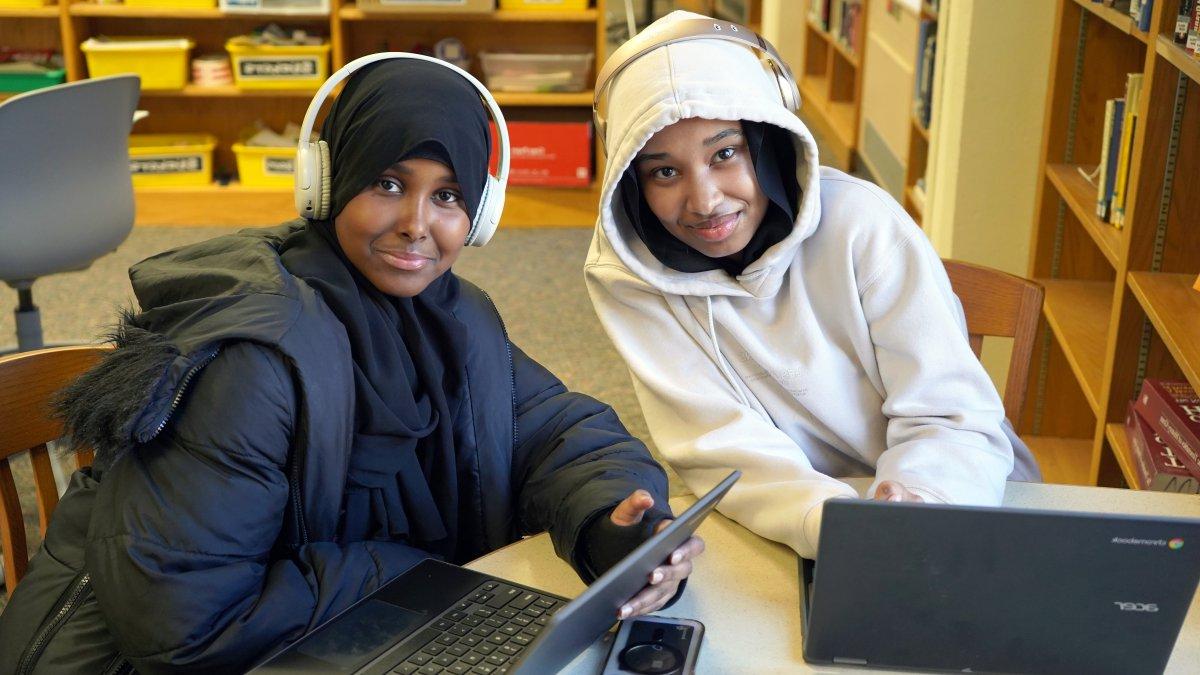 Two students working on laptops